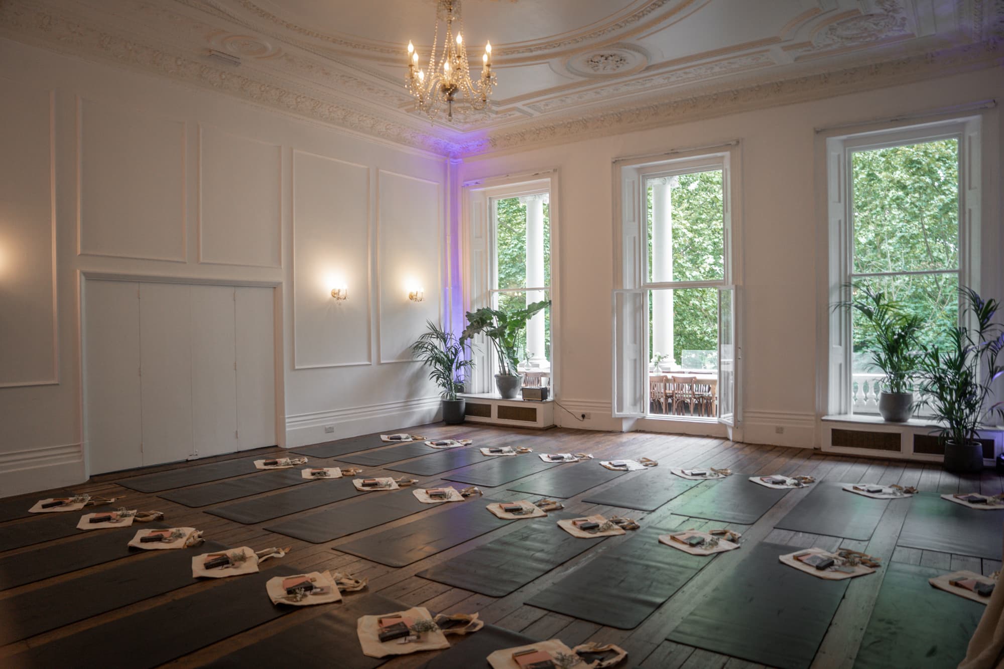 Elegant event space with wooden floor, ideal for yoga retreats and wellness sessions.