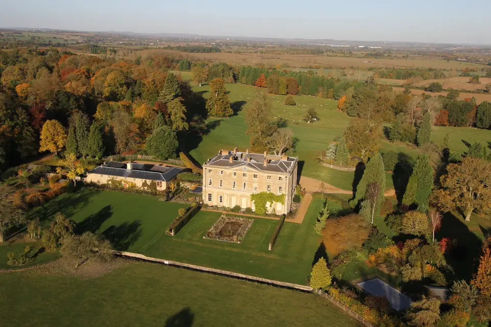 Elegant Courteenhall Estate room, surrounded by autumn foliage, ideal for weddings and corporate retreats.
