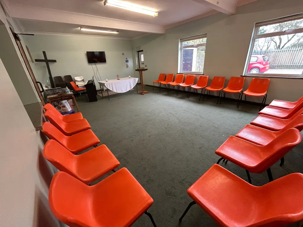 Interview Room at Barnsbury Centre with orange chairs, ideal for workshops and discussions.
