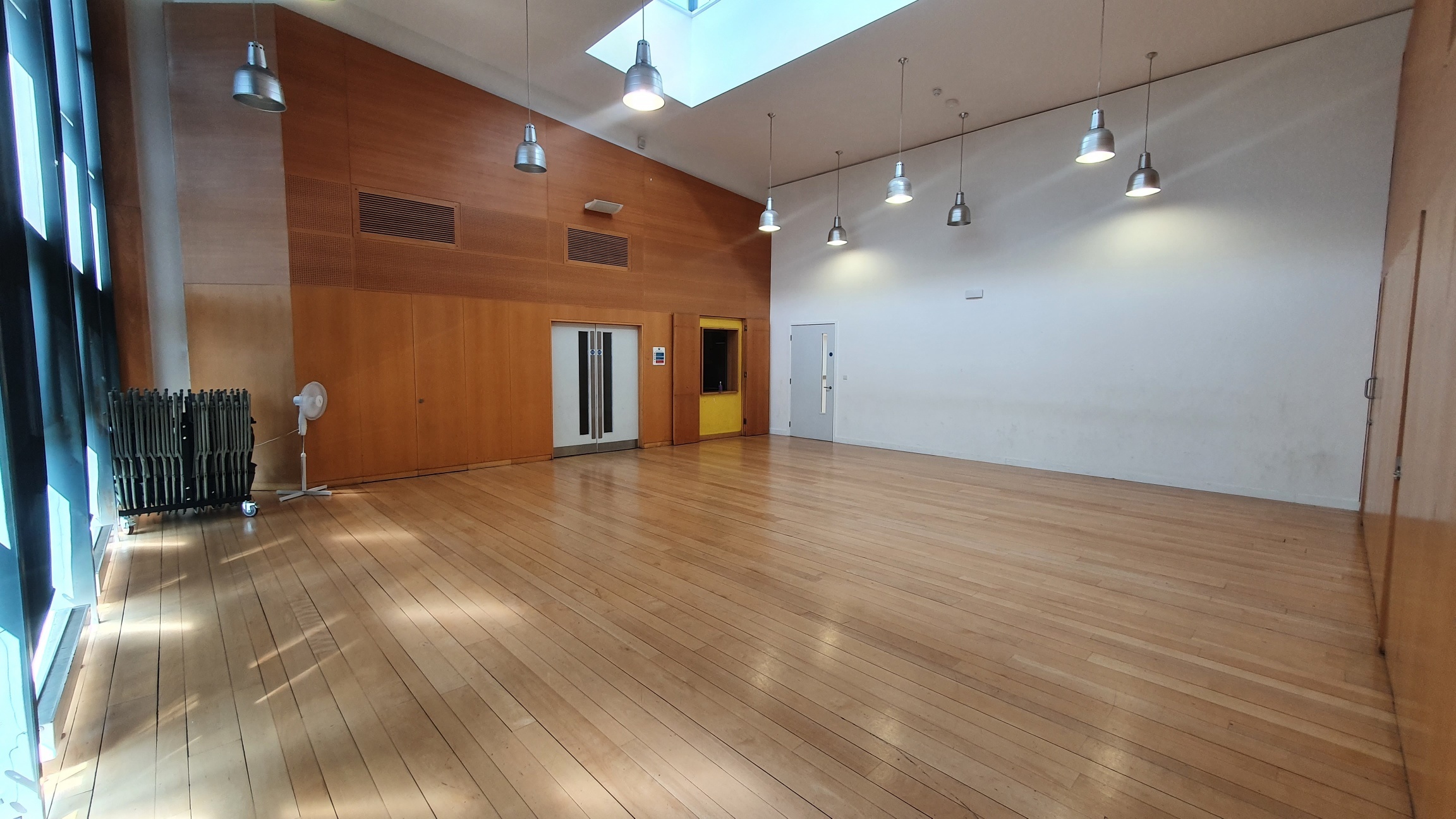 Spacious interview room with wooden flooring, ideal for meetings and workshops.