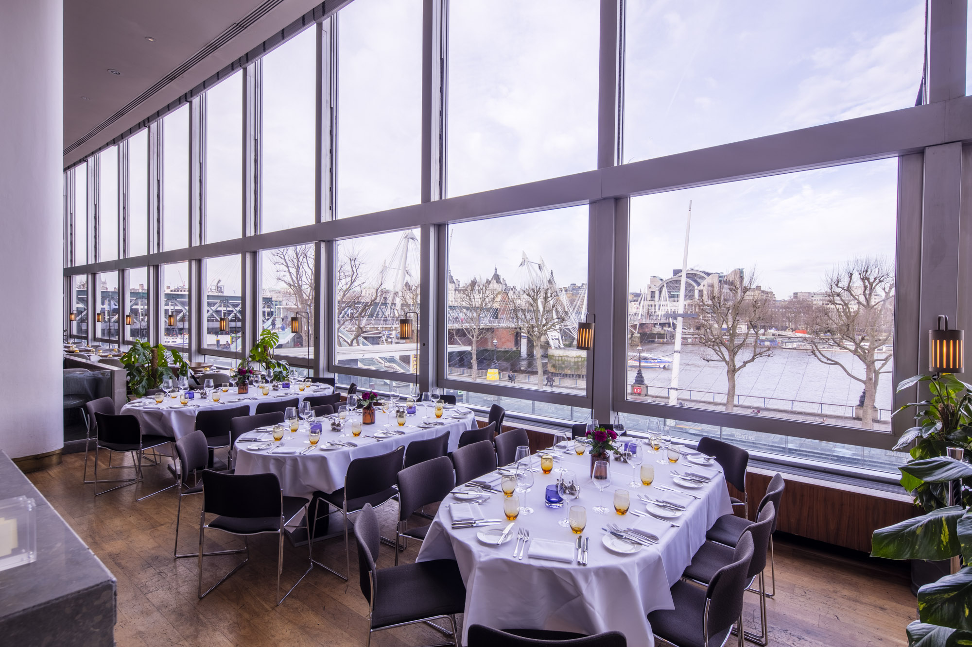 Elegant dining space with waterfront view, perfect for corporate events and gatherings.