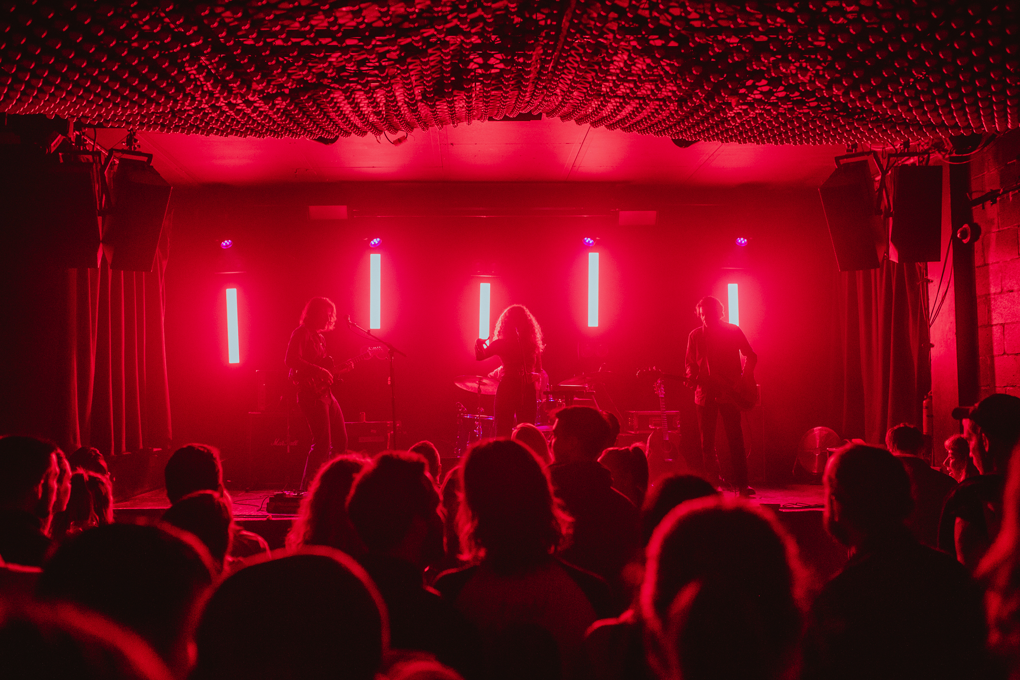Vibrant live music event at The Live Room, Colours Hoxton with dynamic red stage lights.
