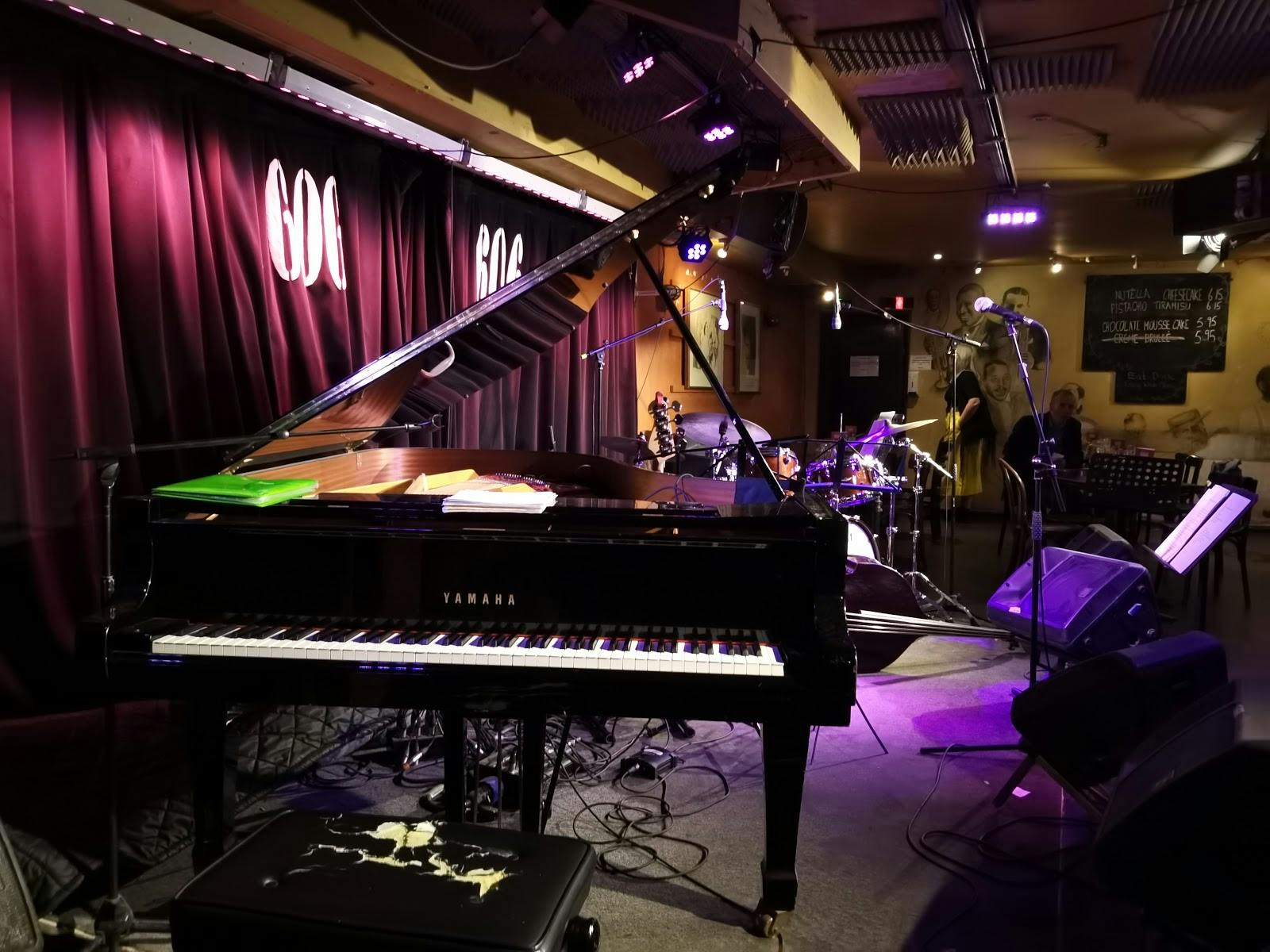 Live music venue at The 606 Club with polished grand piano, perfect for events.