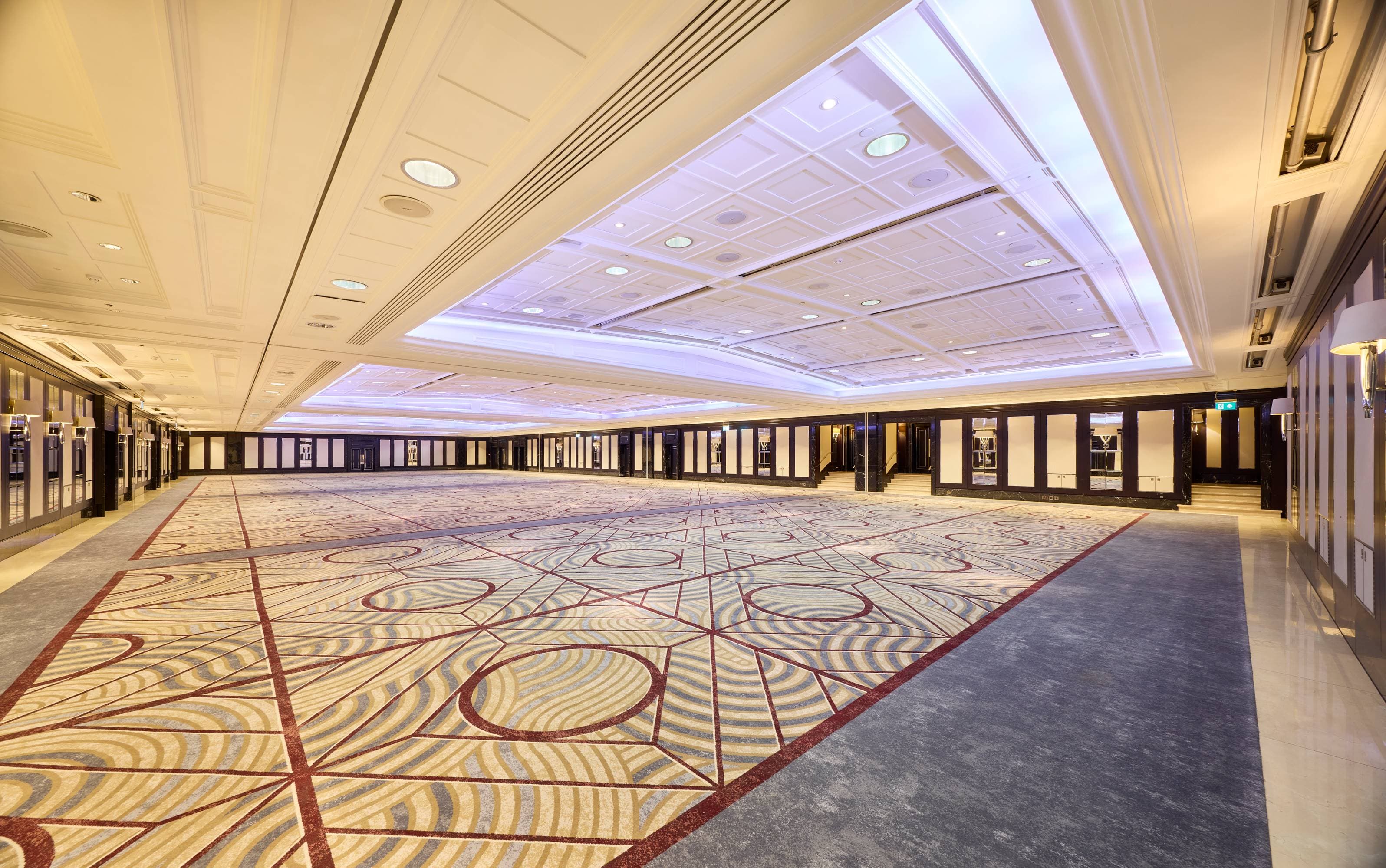 Modern ballroom event space with high-end ceiling lighting for corporate events and weddings.