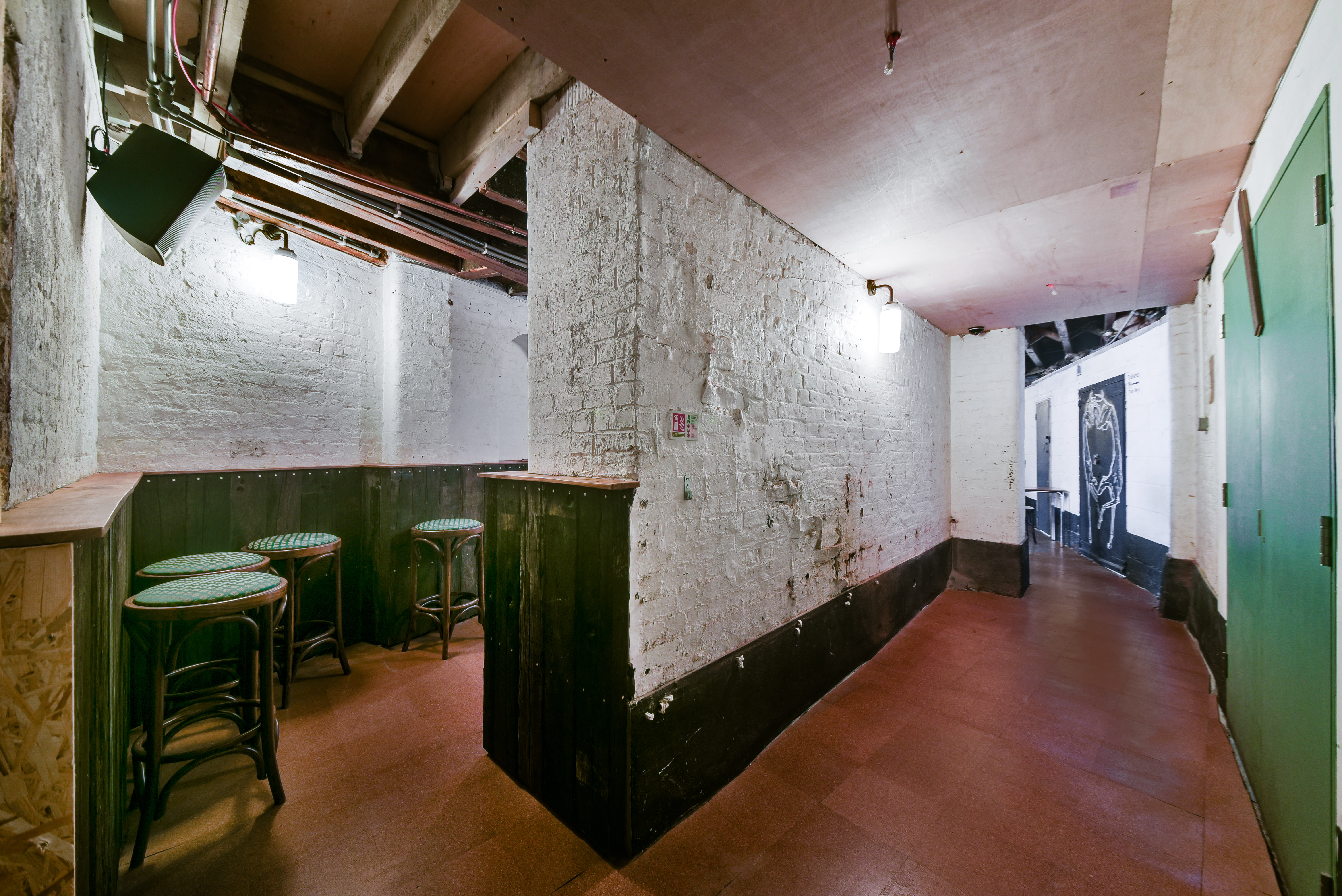Cozy corridor with exposed brick at The Greyhound, perfect for networking events.