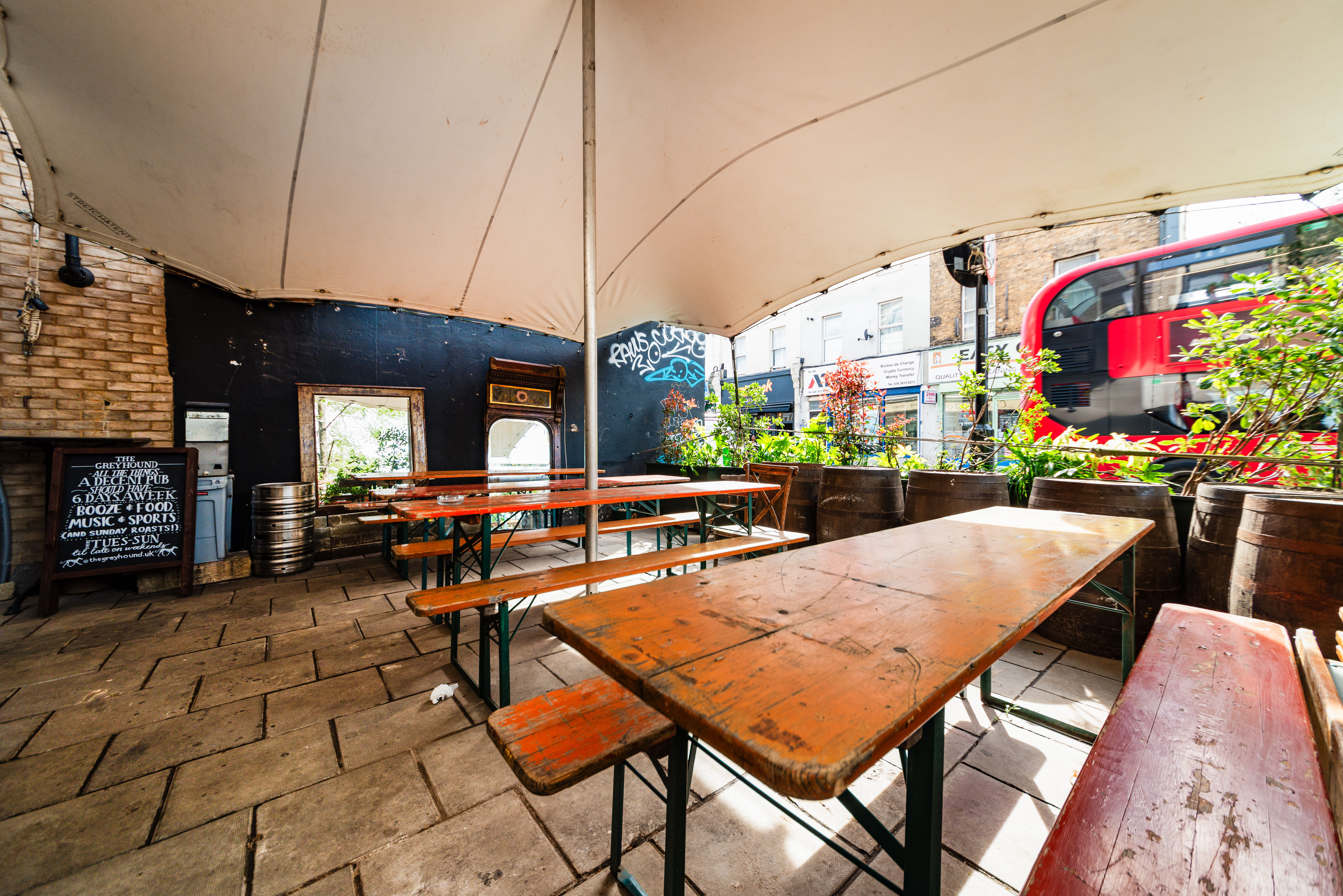 Outdoor event space at The Greyhound Peckham with rustic tables for casual gatherings.