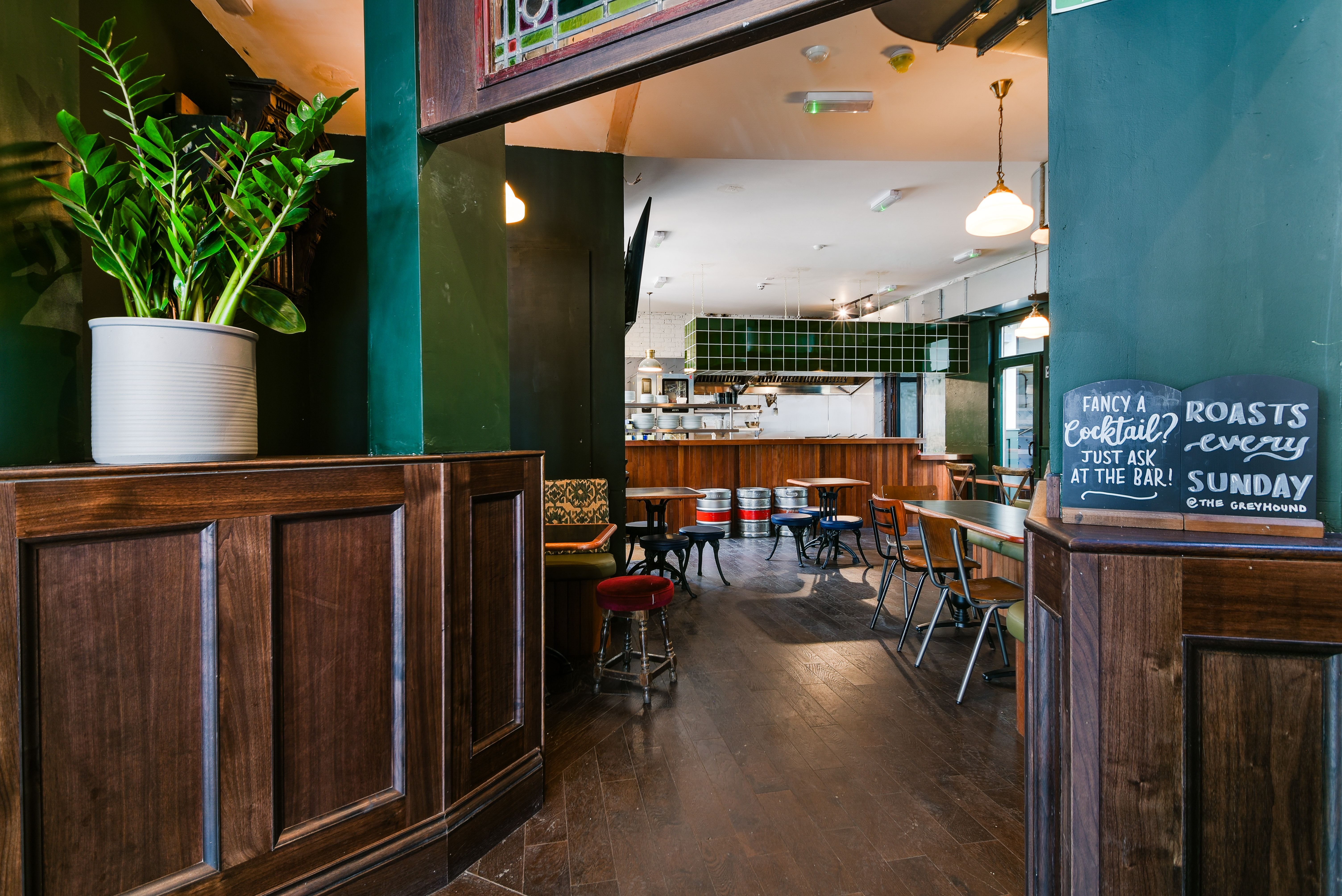 Versatile event space at The Greyhound Peckham with wooden accents, ideal for meetings and gatherings.