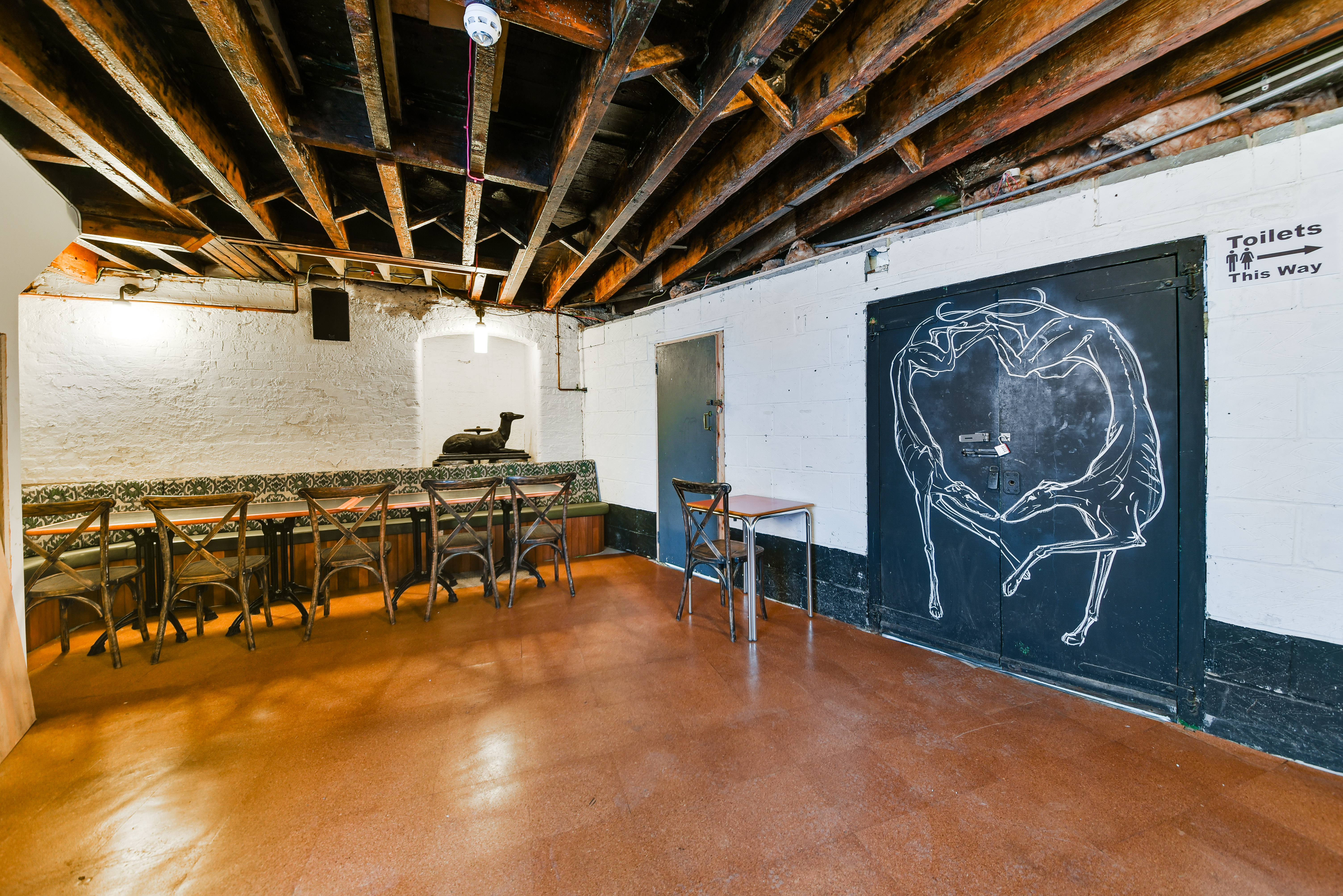 "Rustic event space at The Greyhound Peckham with exposed beams for creative meetings."