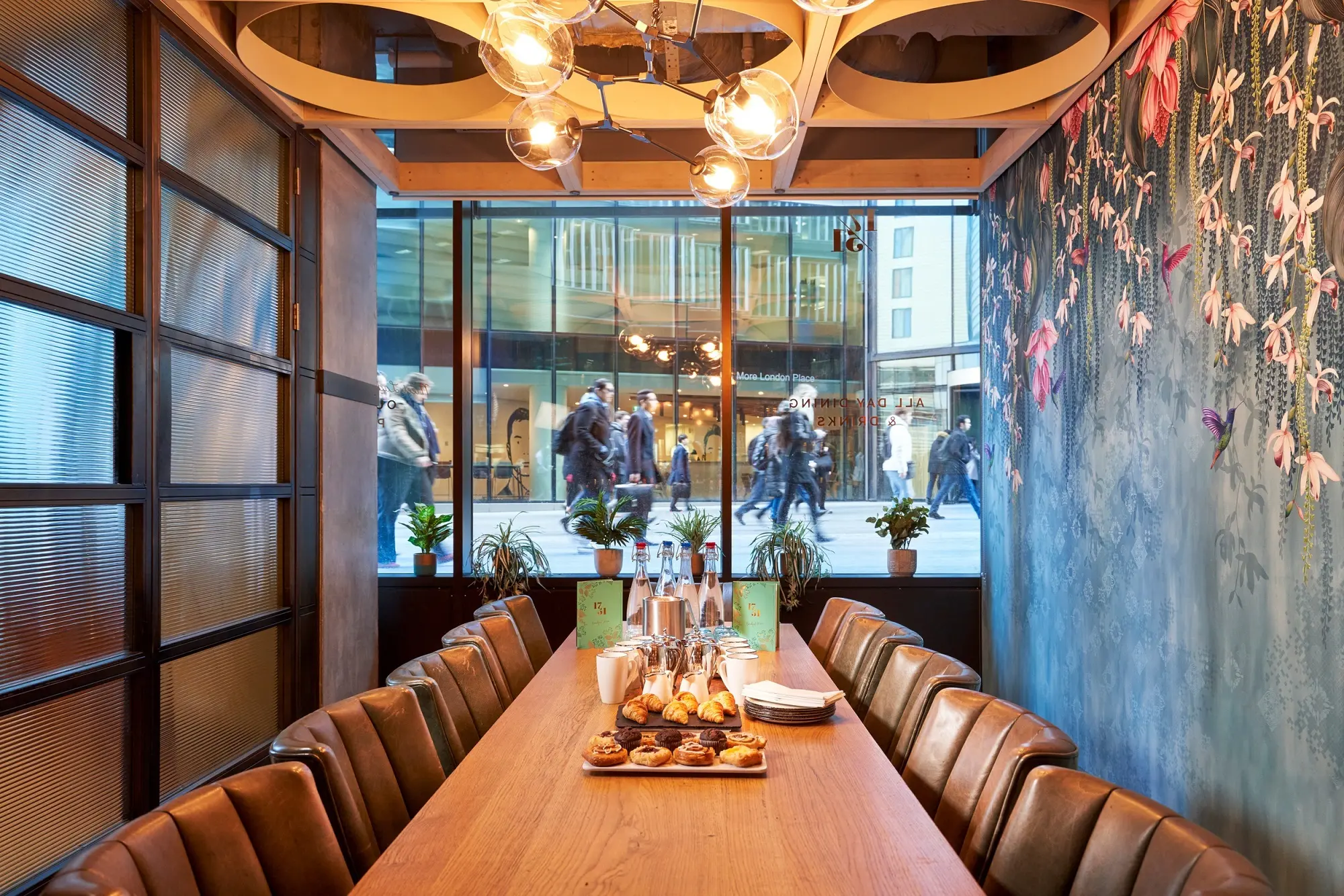 Private meeting room in The Distillery London with a wooden table and leather chairs.