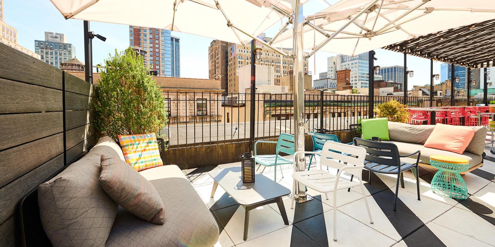 Stylish rooftop event space with urban skyline, ideal for networking and gatherings.
