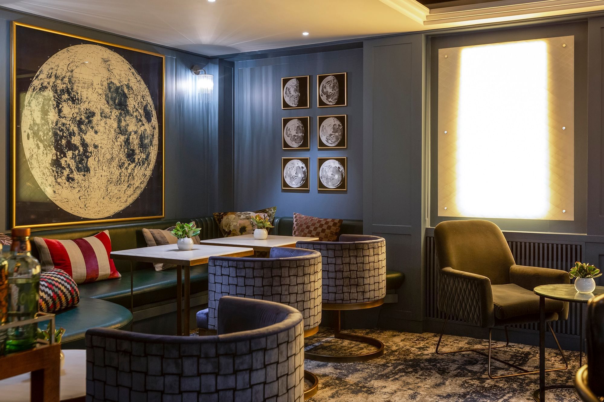 Sophisticated meeting space with moon artwork, ideal for creative gatherings and events.
