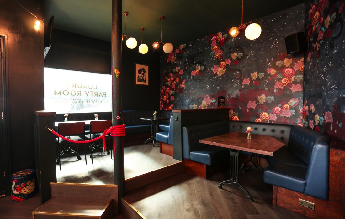 Karaoke room at Star of Bethnal Green with floral wallpaper for private parties.