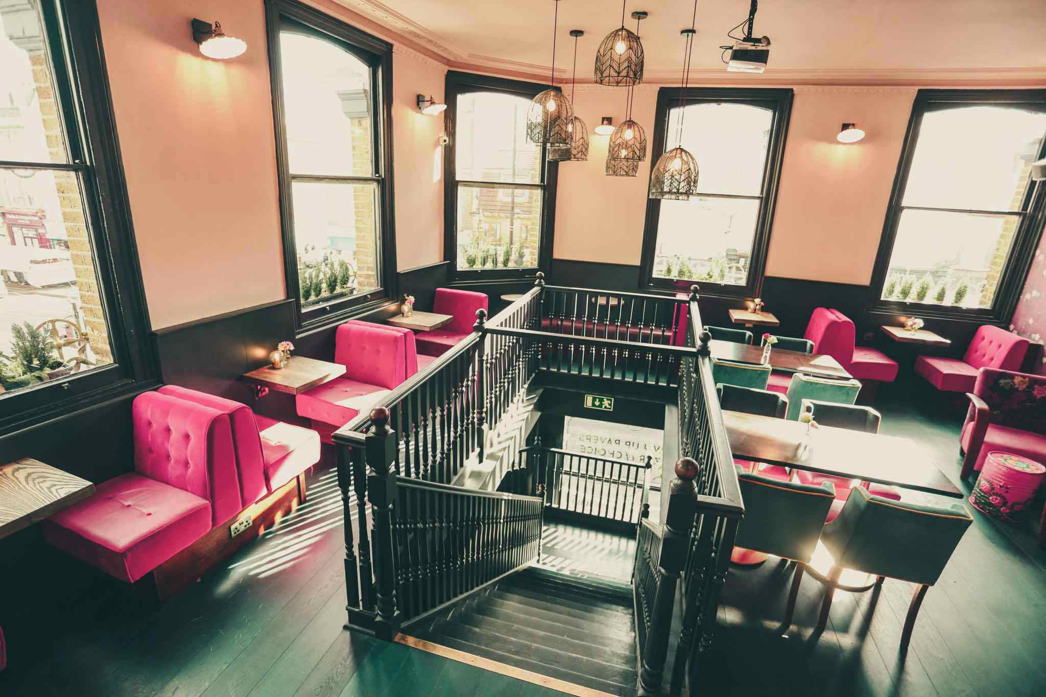 Stylish Downstairs Bar with pink seating, ideal for networking events in Bethnal Green.