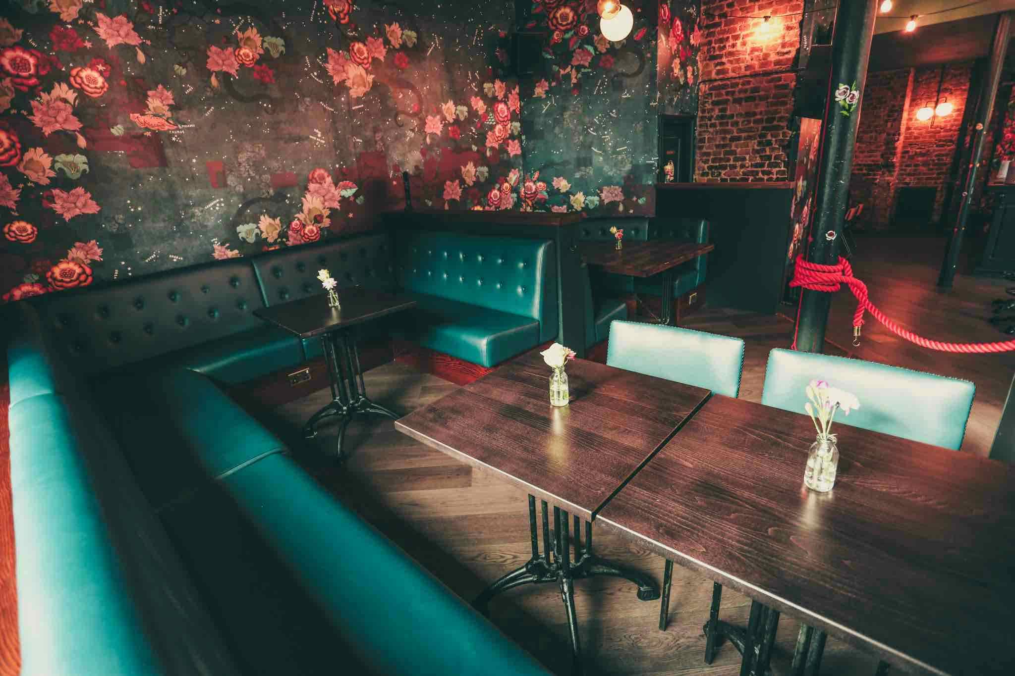 Stylish Downstairs Bar with floral wallpaper, perfect for private events and gatherings.