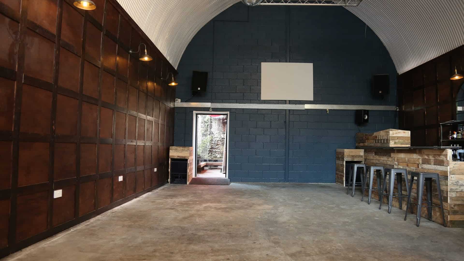 Indoor event space with high arched ceiling at Bermondsey Social Club for versatile gatherings.