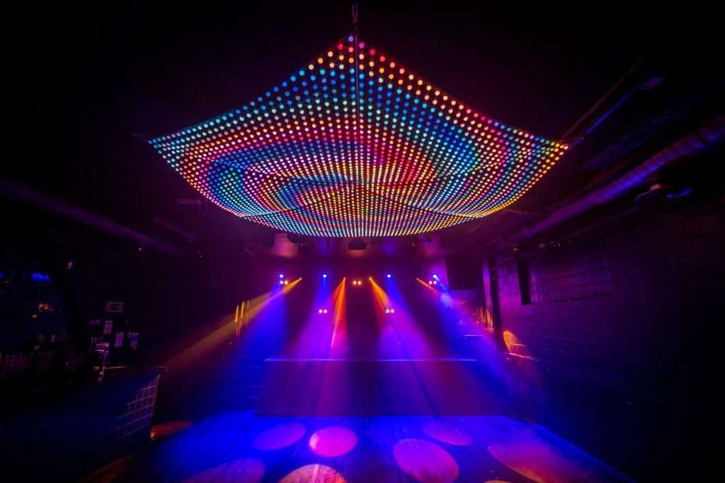 Vibrant Multiroom Event Space with LED lights for lively gatherings and dance events.