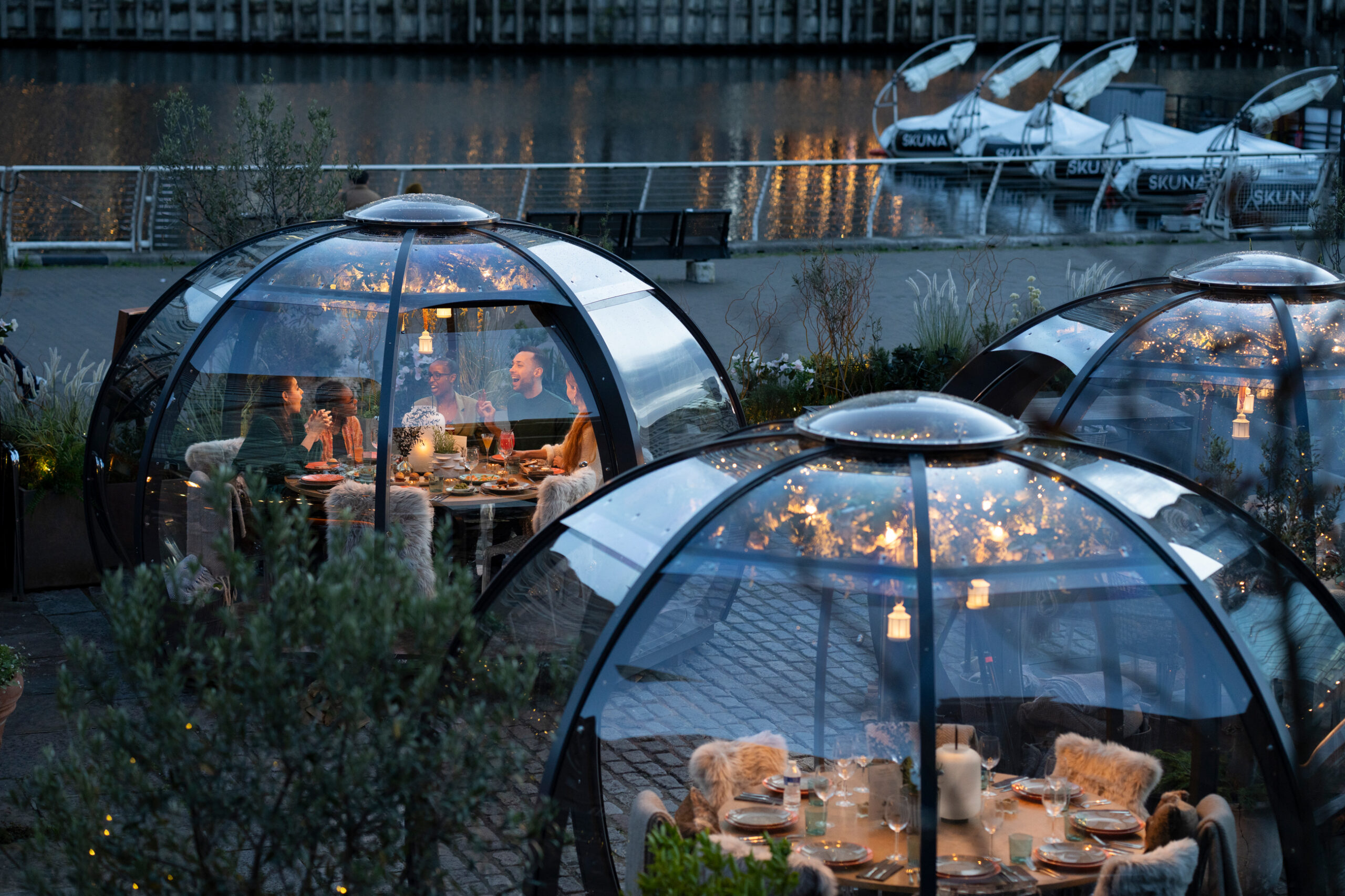 Outdoor dining with transparent domes at The Sipping Room for events and gatherings.