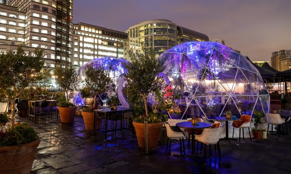 Stylish outdoor event space with illuminated geodesic domes for unique gatherings.
