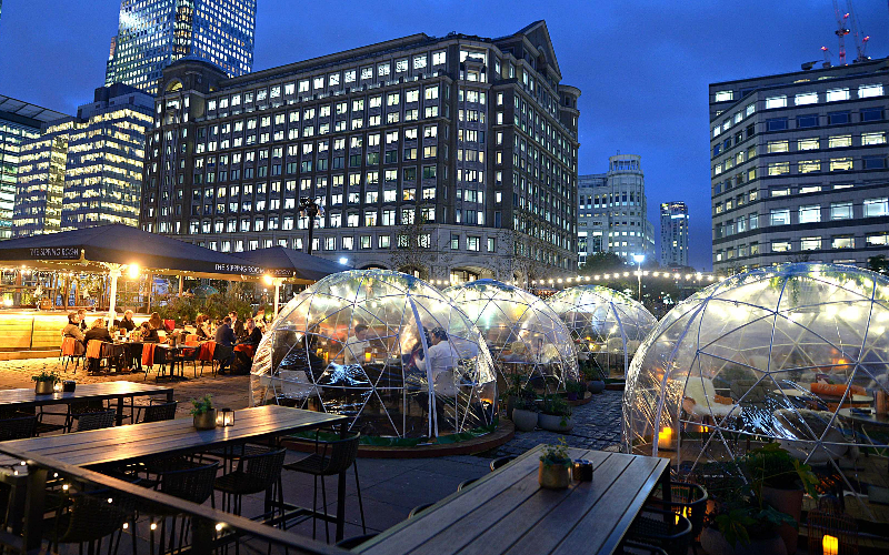 Vibrant rooftop venue with igloo structures for unique outdoor events in urban skyline.