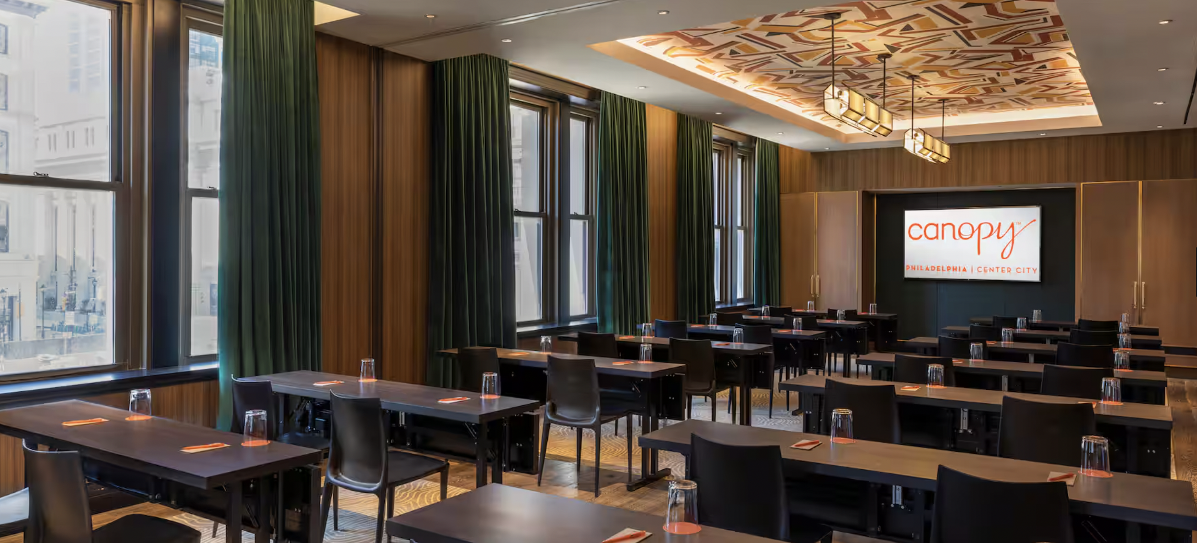 Modern Wanamaker Room with sleek tables for corporate meetings in Canopy by Hilton.