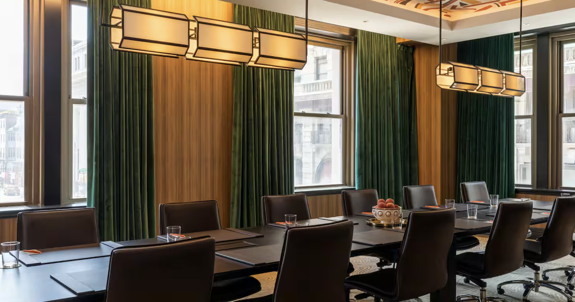 Wanamaker Room at Canopy by Hilton: elegant meeting space with green curtains for corporate events.