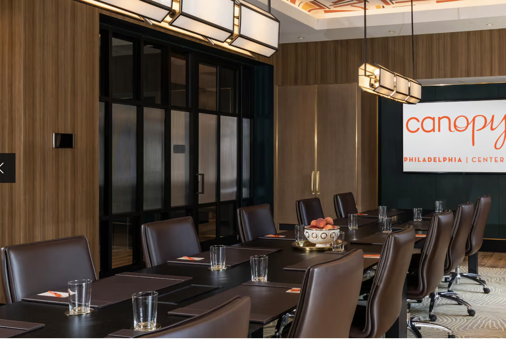 Wanamaker Room at Canopy by Hilton: modern meeting space with leather chairs for corporate events.