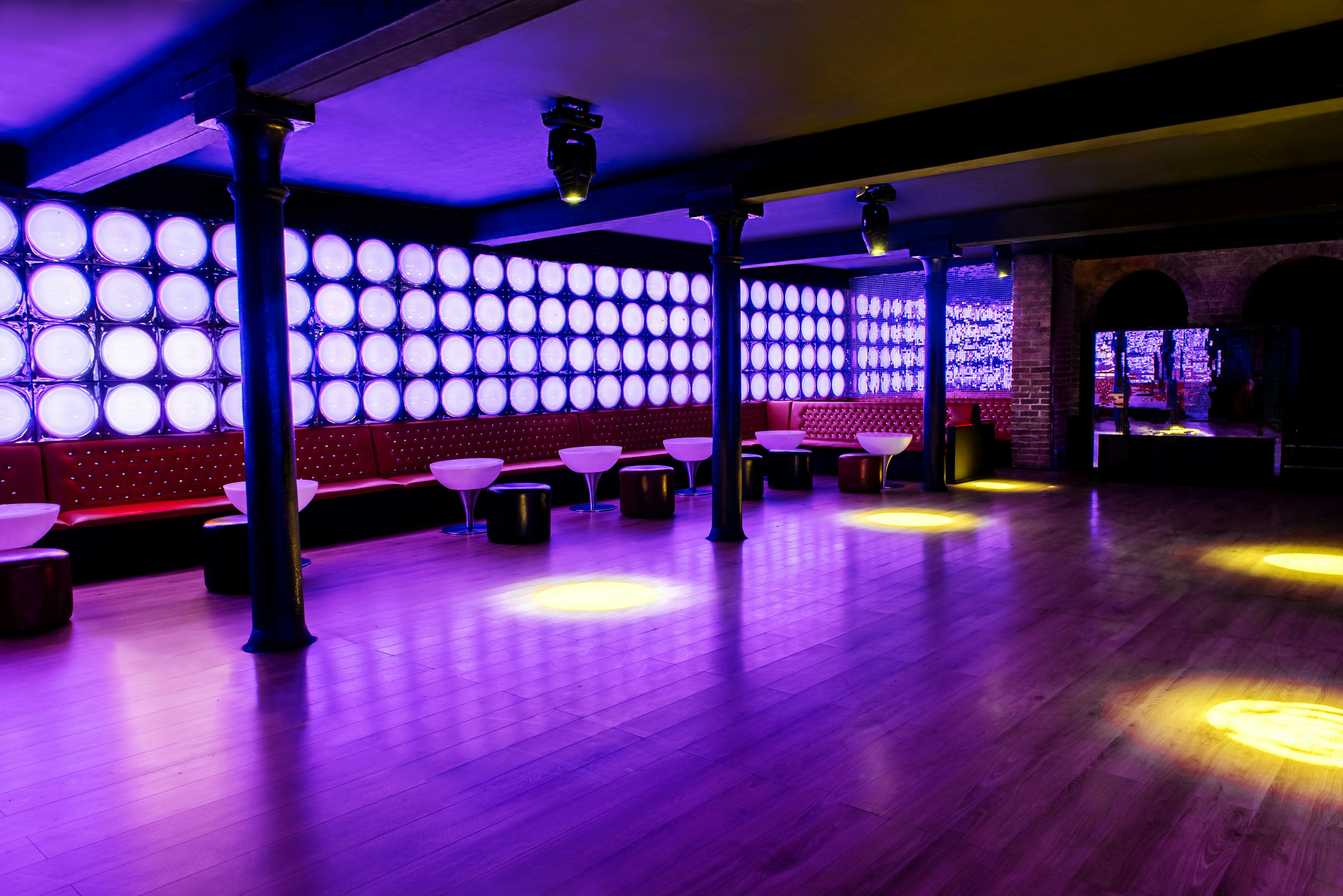 Modern event space with purple lighting, perfect for corporate and social gatherings.