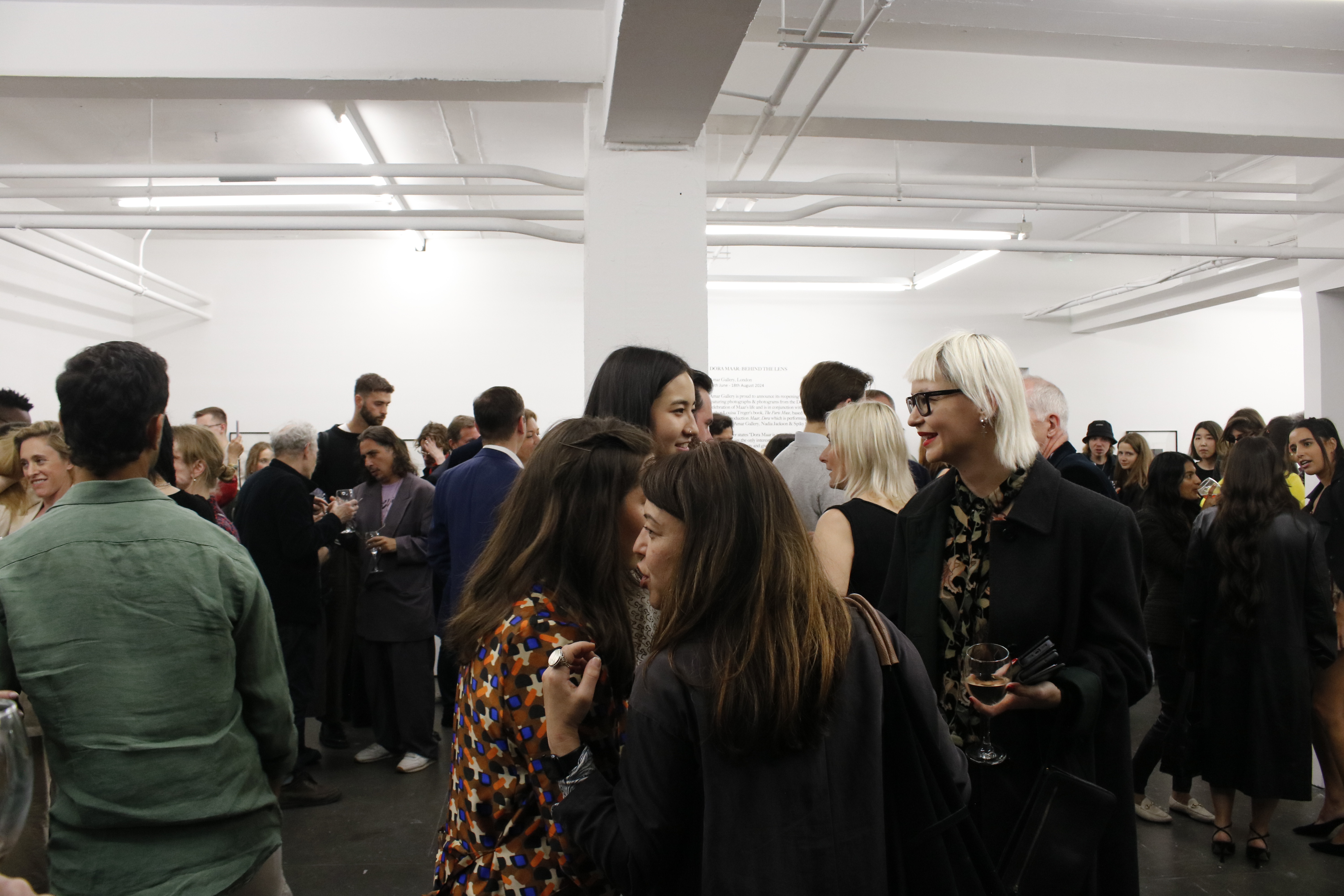 Vibrant networking event in modern Fitzrovia Gallery, fostering connections and collaboration.