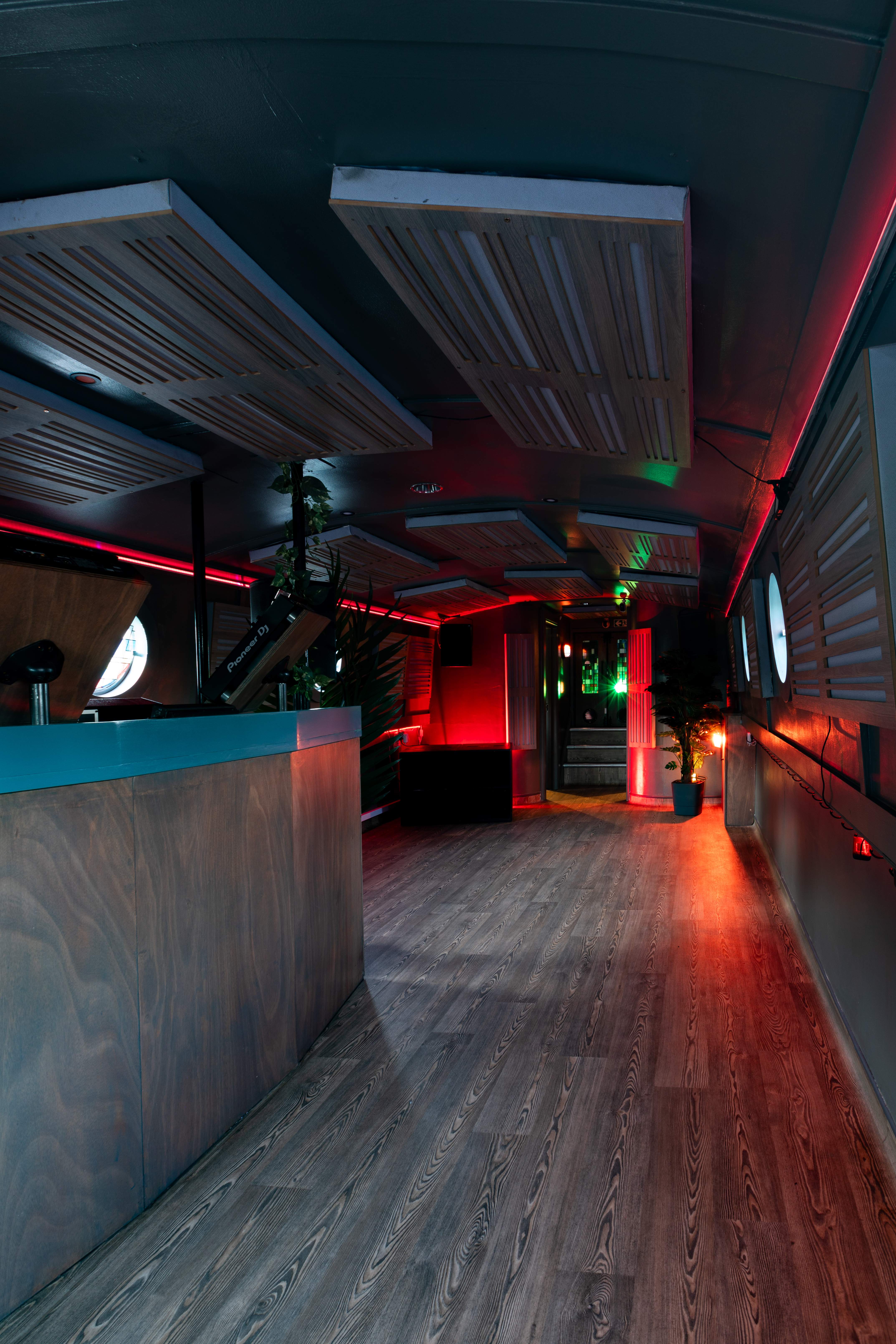 Modern floating mobile event space with ambient lighting for versatile gatherings.