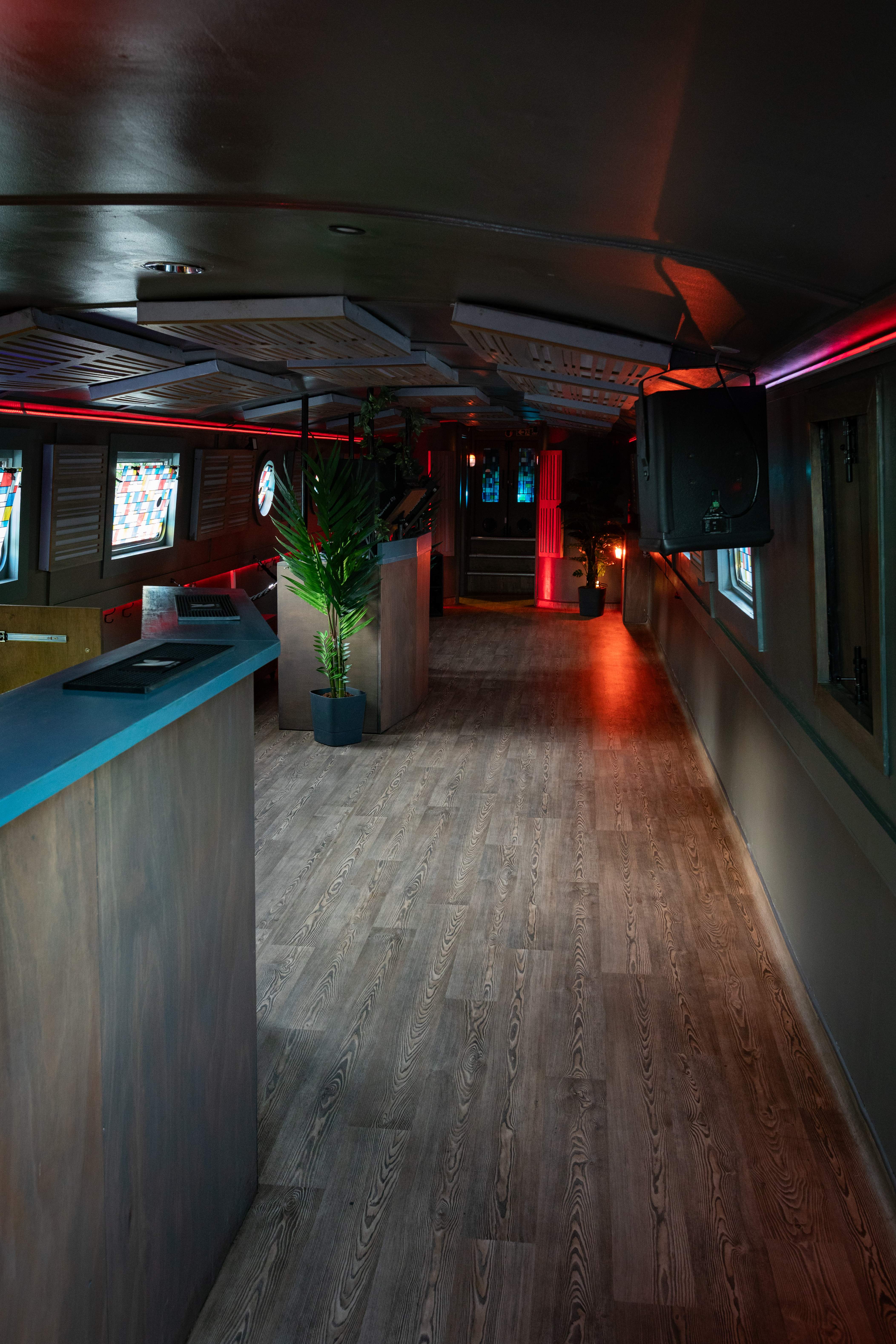 Floating mobile event space with warm lighting, ideal for networking and gatherings.