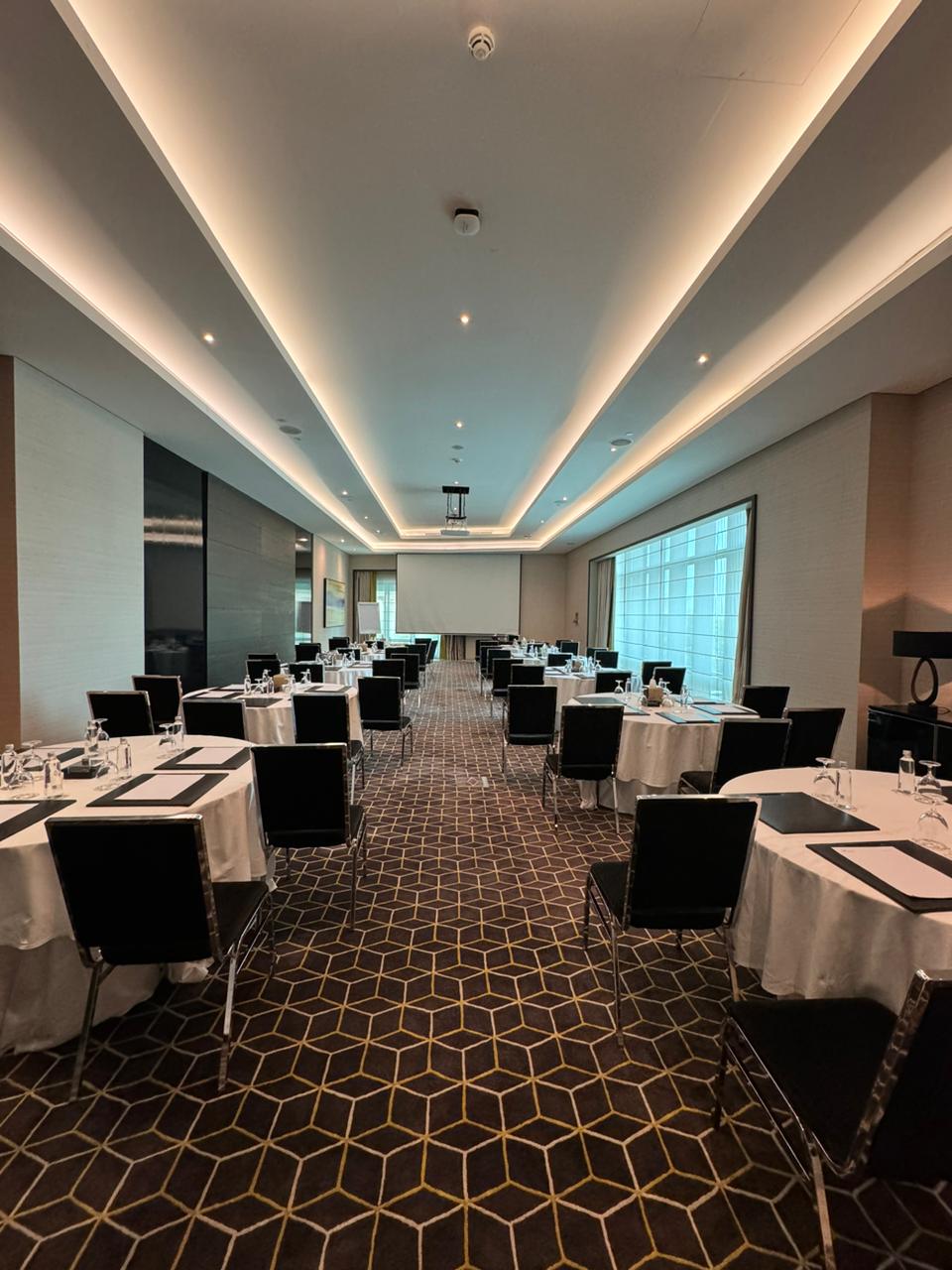 Corporate meeting room in Dammam with elegant round tables for events.