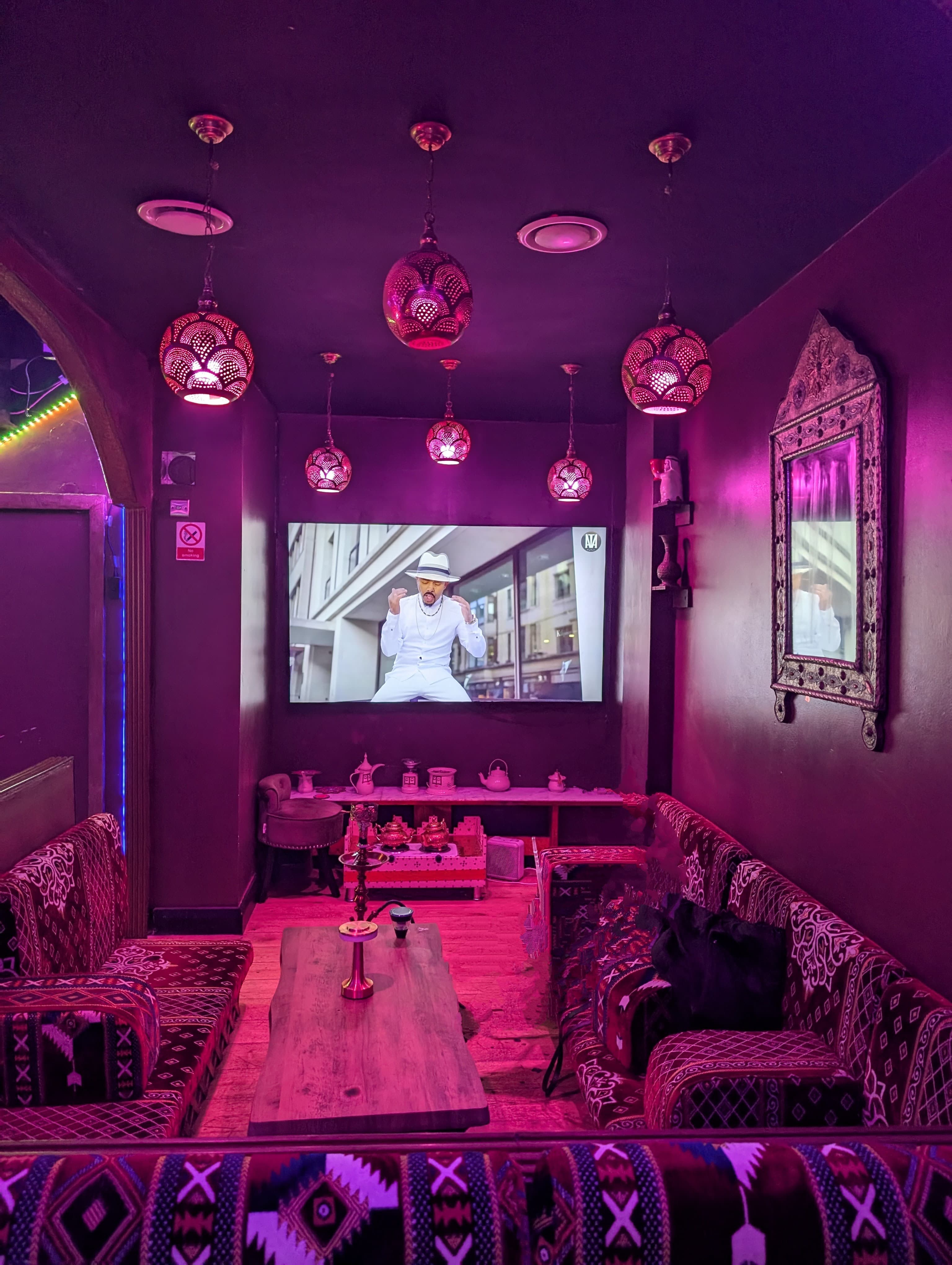 Vibrant Dream Lounge event space with large screen, ideal for networking and gatherings.