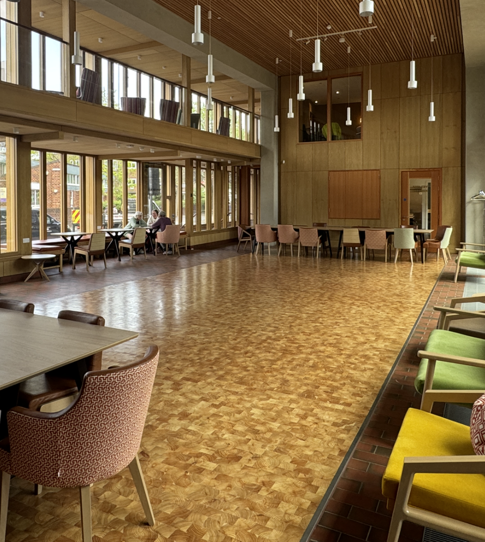 Spacious event space with large windows, ideal for meetings and workshops.