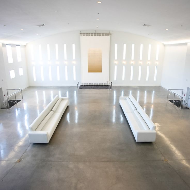 Spacious minimalist event space with white sofas at The Temple House for receptions.