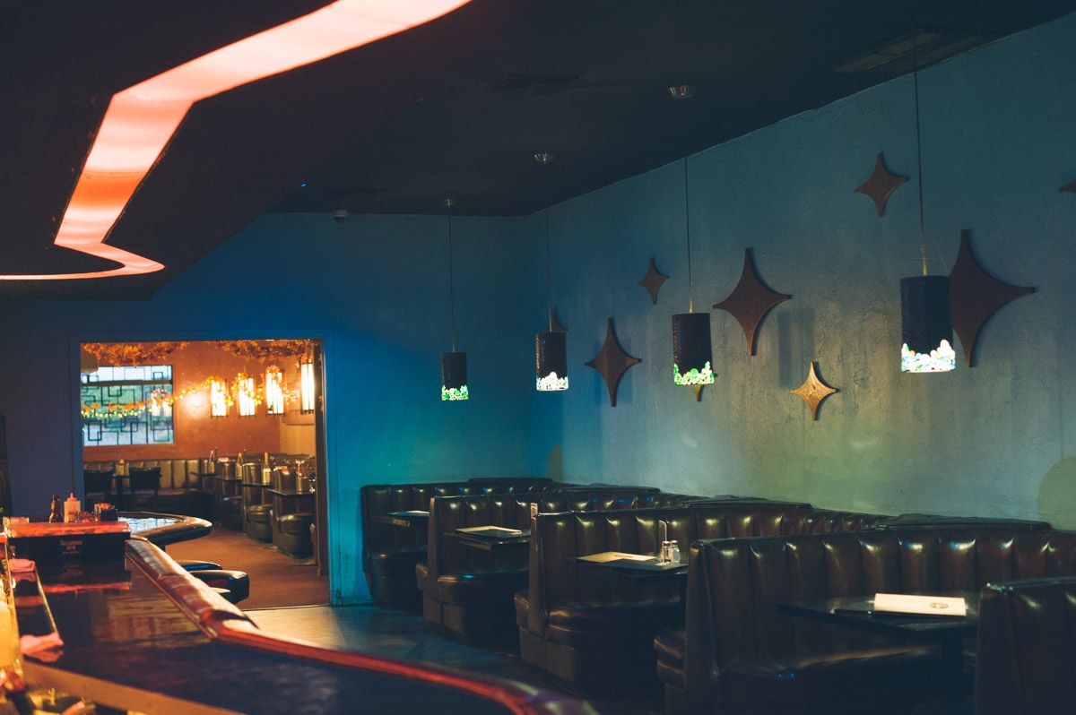The Turquoise Room at Riviera Supper Club, featuring cozy leather seating and vibrant decor.