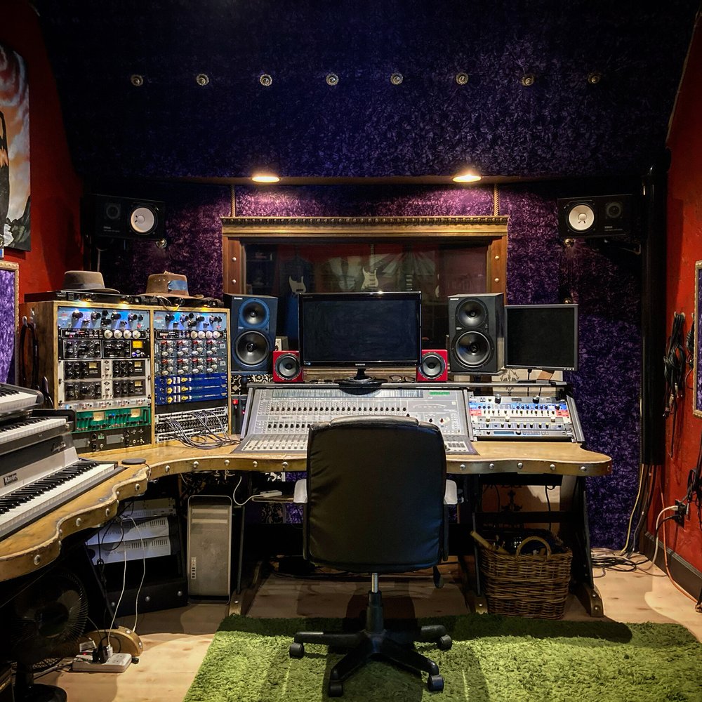 Recording studio with mixing consoles, ideal for music events and audio production.