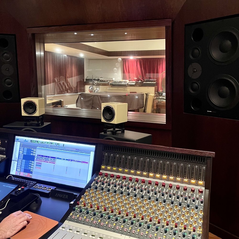 Professional audio recording studio with mixing console for workshops and events.