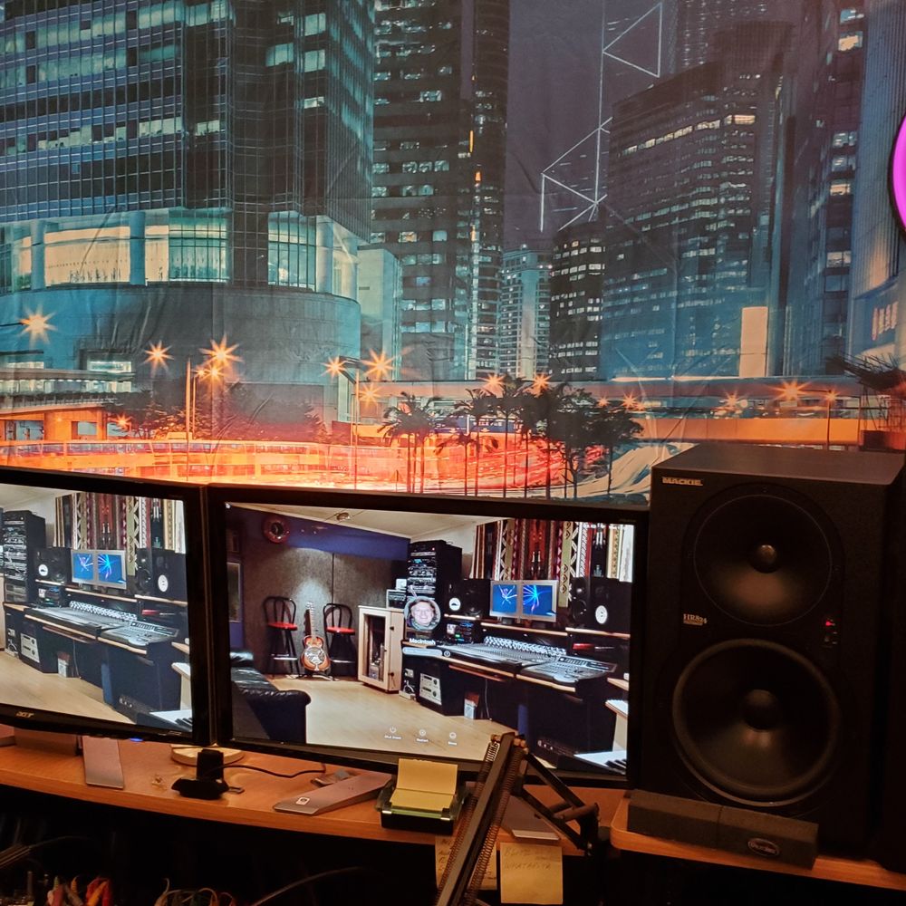 Recording studio with city skyline backdrop, ideal for music events and tech conferences.