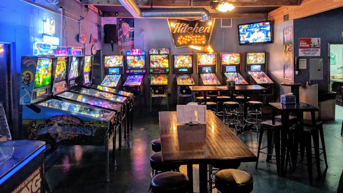 Vibrant arcade with pinball machines, perfect for casual networking events and team-building.