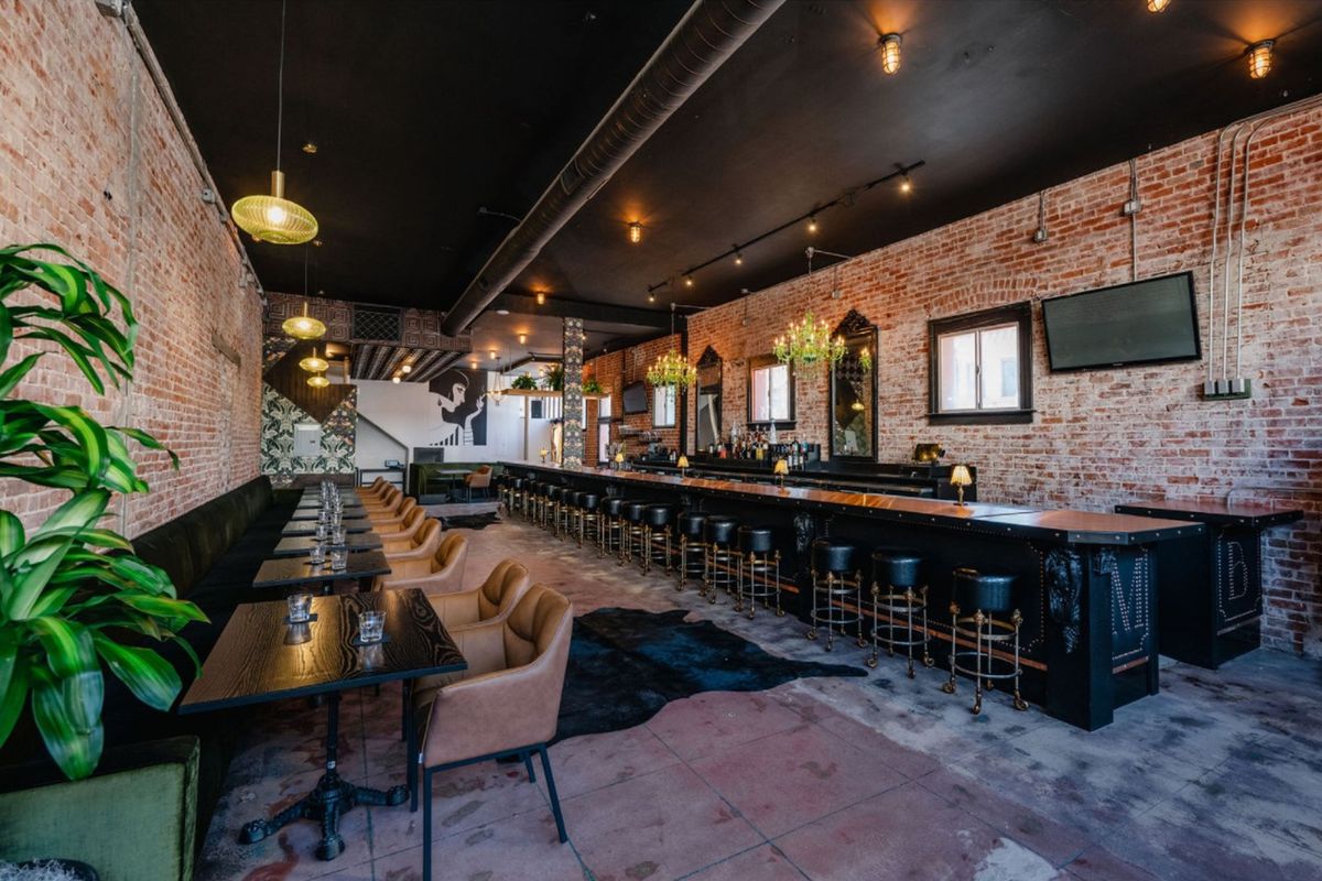 Stylish lounge with exposed brick walls, ideal for networking events and intimate dinners.