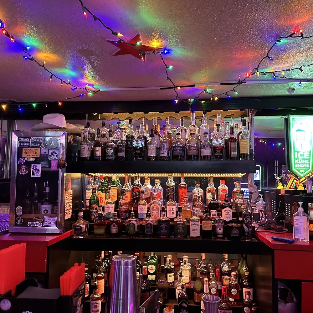 Enclosed Smoking Patio bar with diverse spirits, perfect for networking events and celebrations.