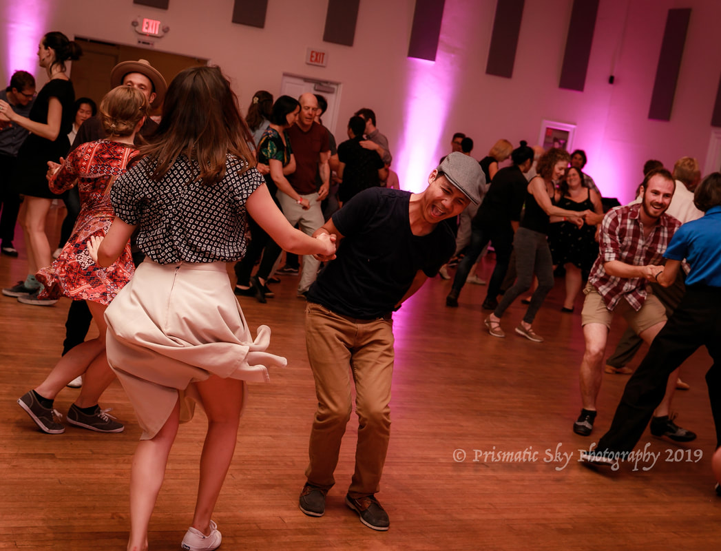 Vibrant dance event at Champion Ballroom with dynamic lighting and lively crowd.