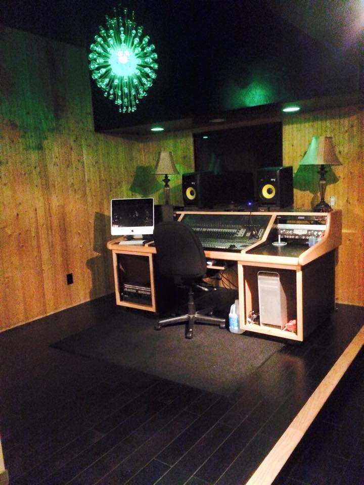 Professional audio recording studio with mixing console, ideal for music production workshops.