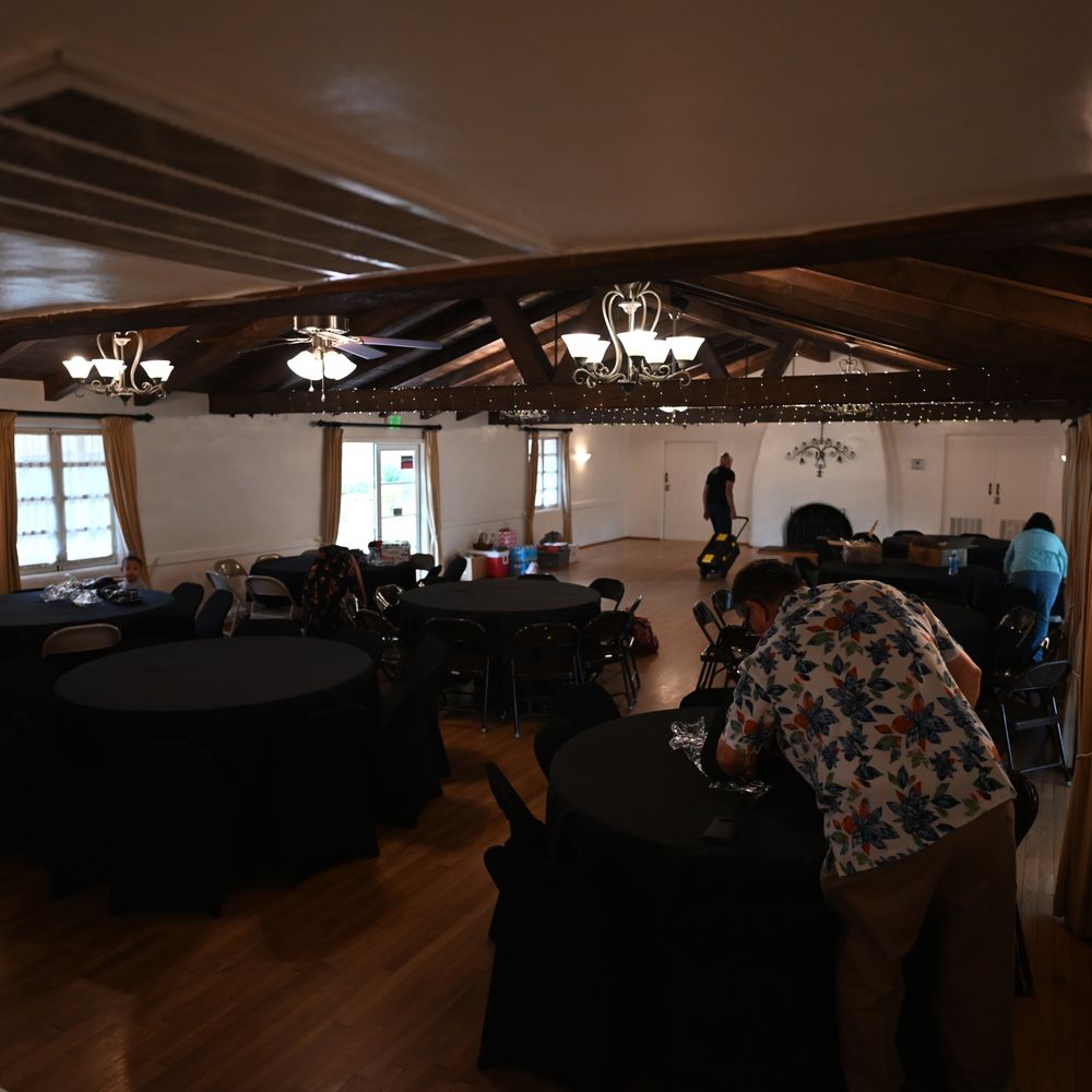 Large indoor banquet hall with rustic charm, ideal for events and gatherings.