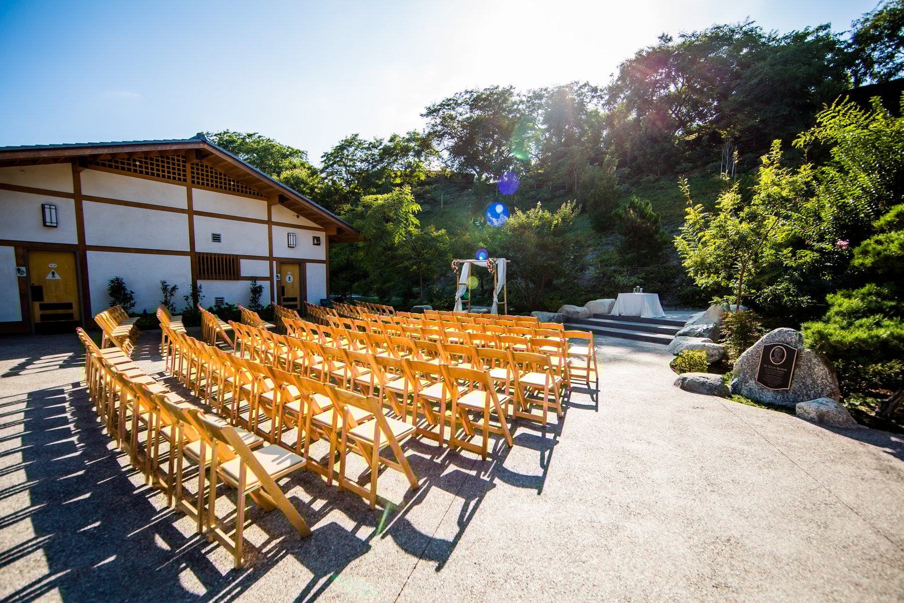 Japanese Friendship Garden outdoor event space with wooden chairs, perfect for weddings and gatherings.