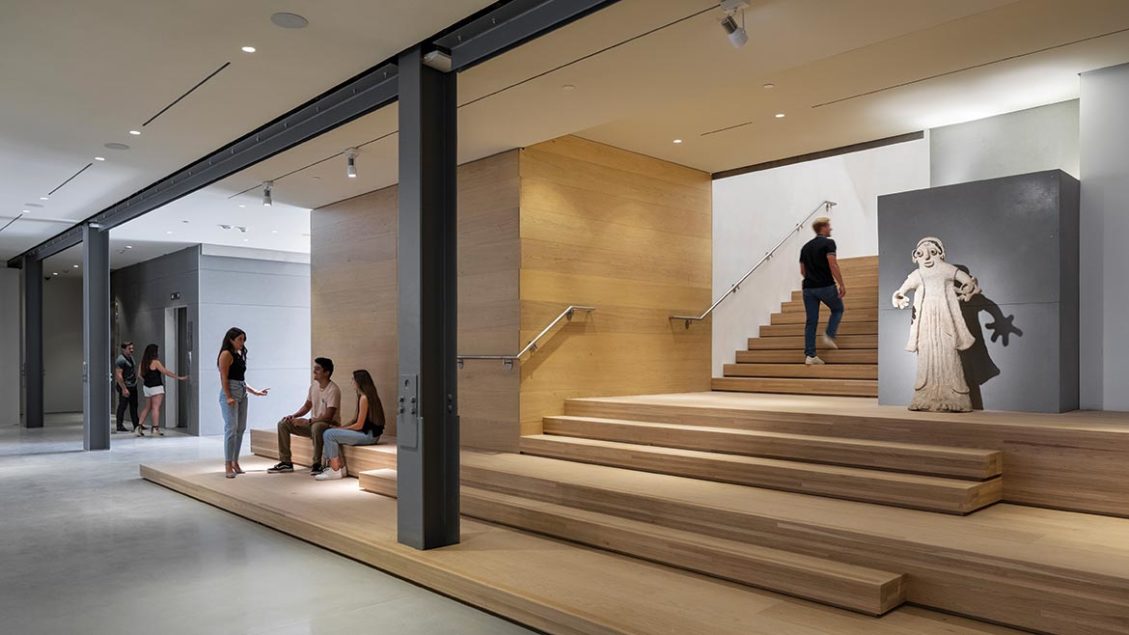 Mingei Museum lobby with wooden steps, ideal for networking events and exhibitions.