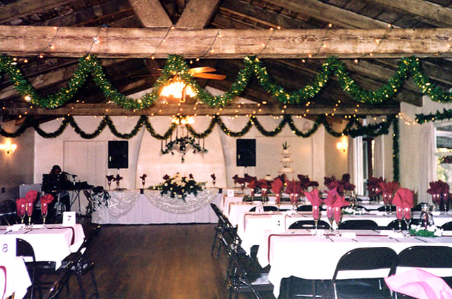 Auditorium at Sweetwater Woman's Club with rustic beams, ideal for weddings and events.