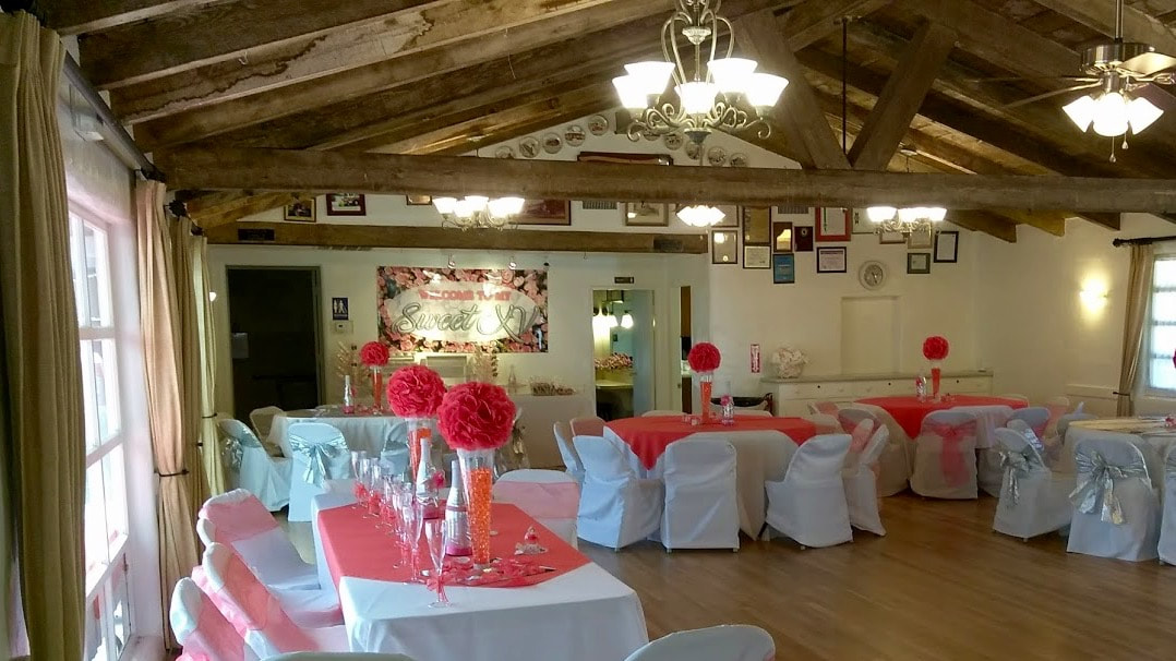 Banquet Hall at Sweetwater Woman's Club with rustic beams, ideal for weddings and events.
