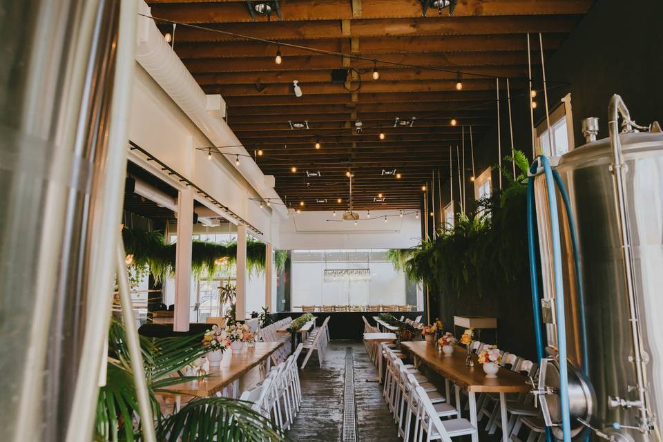 Spacious Tasting Room with wooden beams, ideal for corporate meetings and social gatherings.