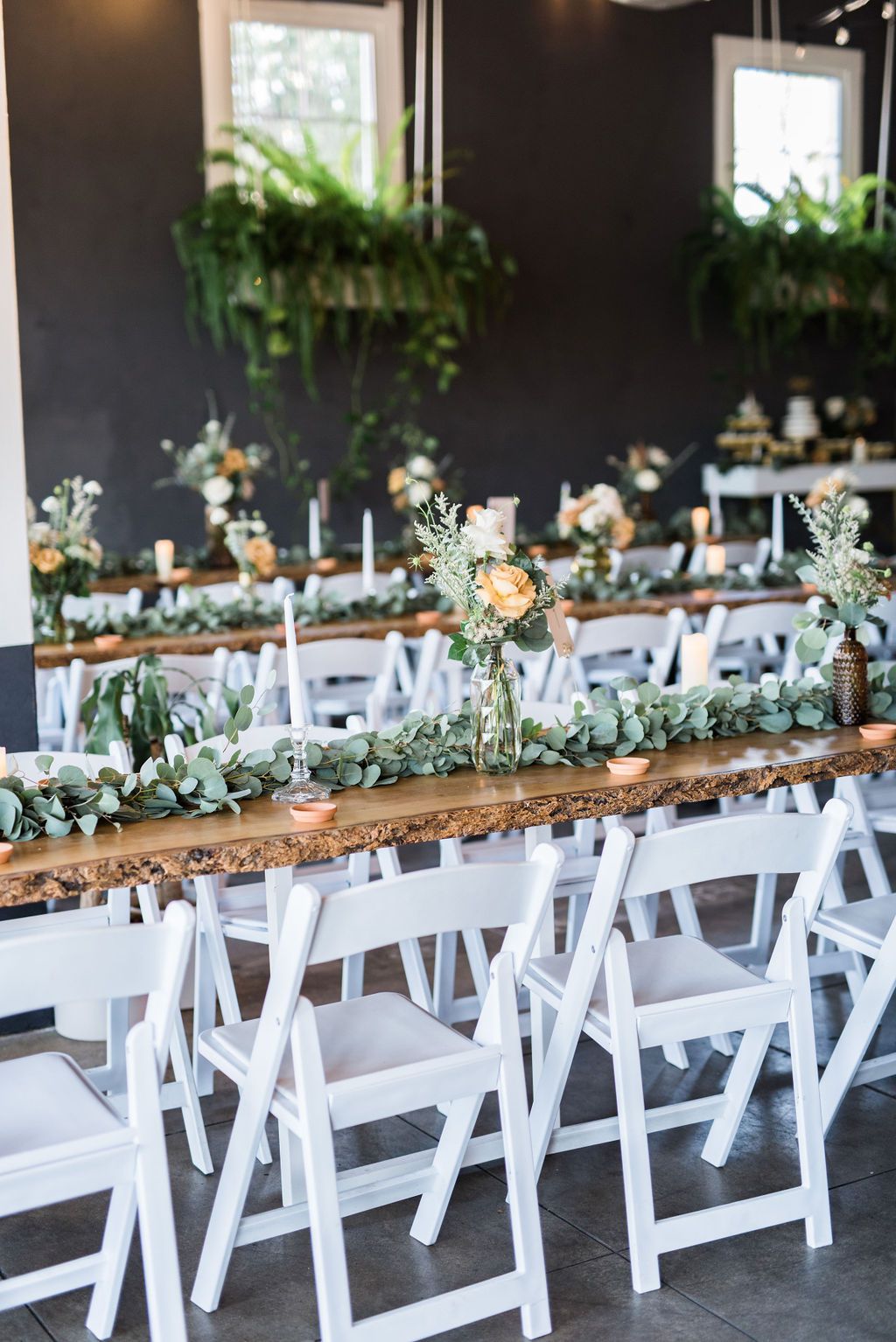 Love Patio event space with wooden tables, greenery, and floral centerpieces for gatherings.